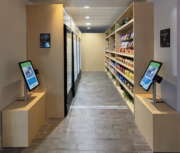 GrabScanGo checkout terminals in a hotel lobby market