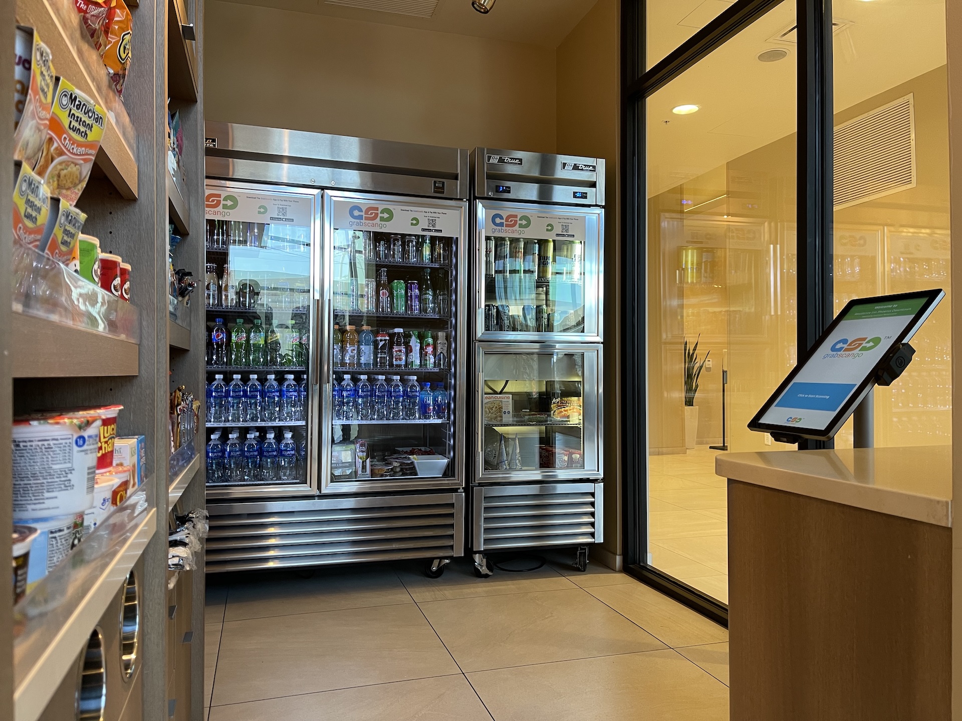 Office snack area with refrigerators and self-checkout kiosk